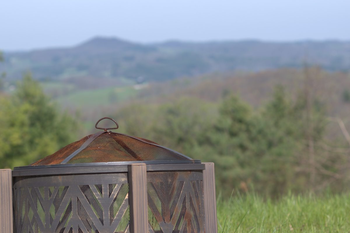 Fire pit with Blue Ridge mountain view at Goodwins Peak
